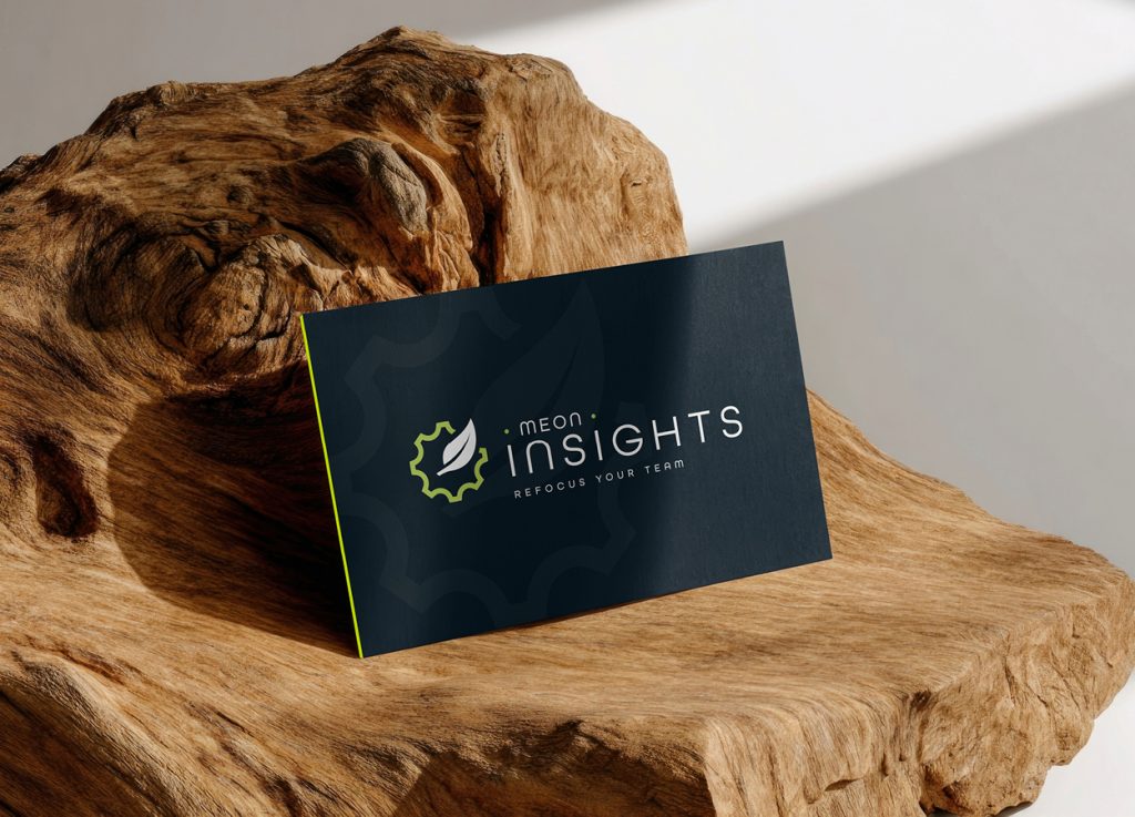 Meon Insights branded business card displayed on wood.