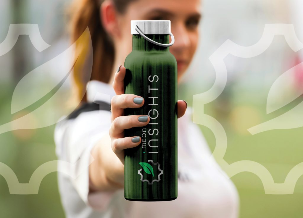 Person holding a branded Meon Insights drinks bottle.